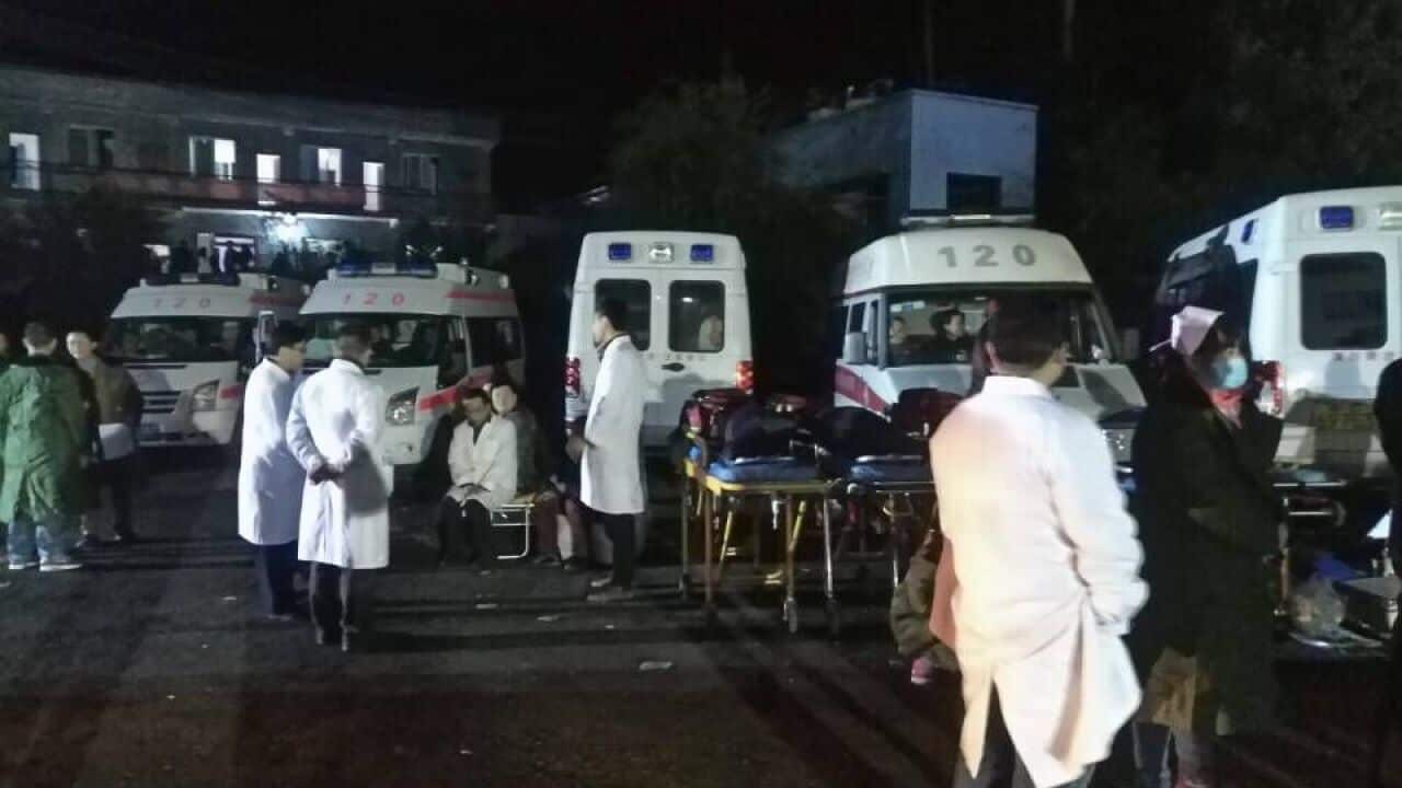Chinese medical workers gather at the accident site after a gas explosion at a coal mine in Laisu town, Yongchuan district, Chongqing, China.