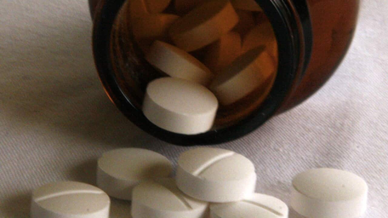 Tablets fall from a jar of medication in Sydney