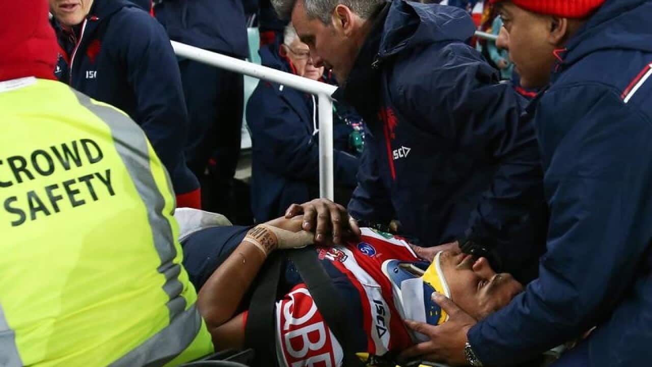 Latrell Mitchell is taken from the Allianz Stadium turf.