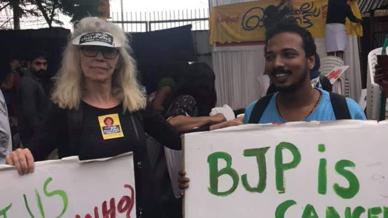 Janne-Mette Johansson (L) takes part in a local protest.