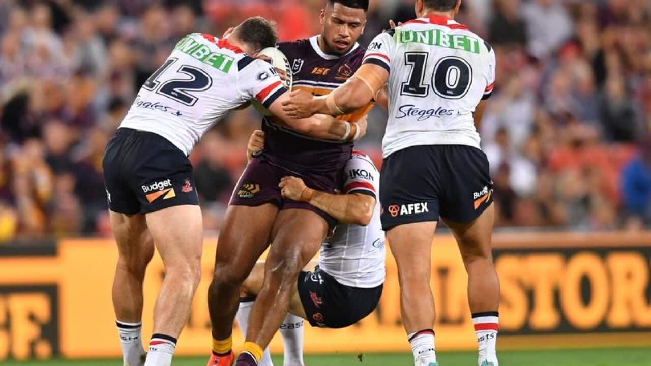 Payne Haas (centre) of the Broncos.