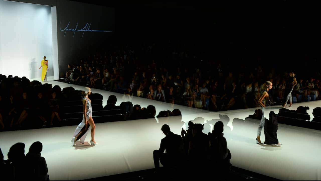 A multiple exposure image of models walking the runway wearing designs by Yousef Akbar during The Innovators show at Australian Fashion Week in Sydney.