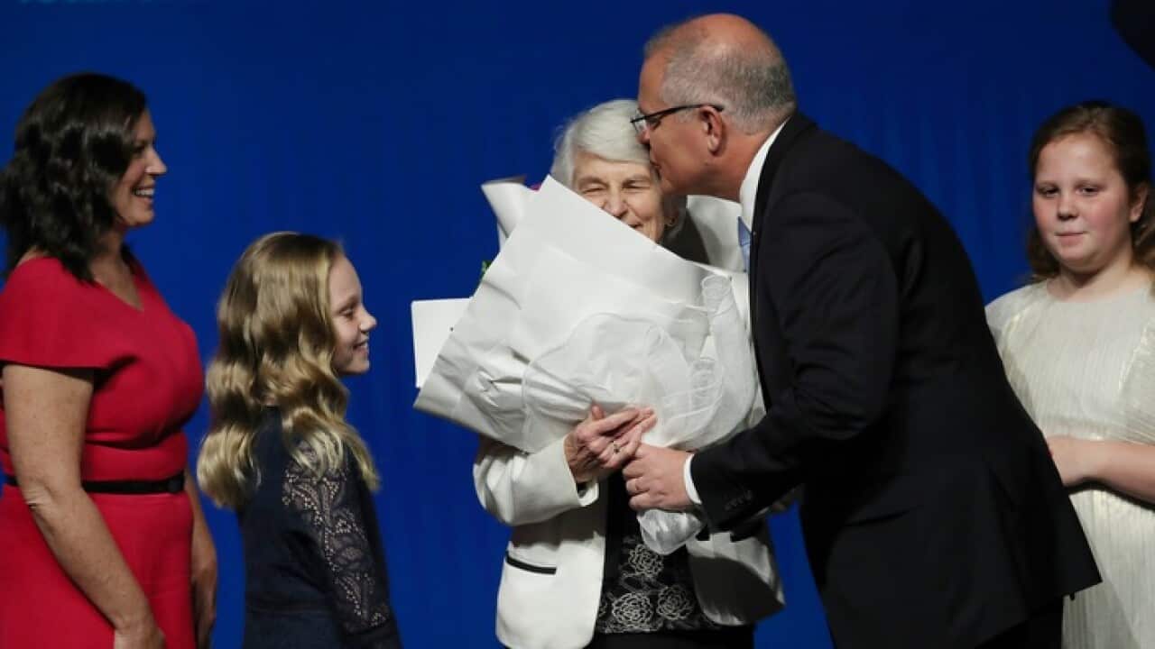 Prime Minister Scott Morrison hands over flowers for mothers day with his wife Jenny (left), mother Marion (centre) and two daughters Abbey ( second left), and