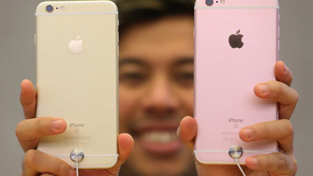 A customer inspects iPhone models