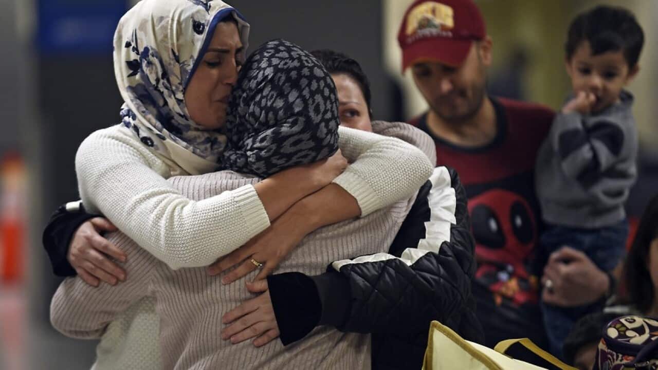 An Iraqi family from Woodbridge, Virginia, welcomes their grandmother at Dulles International Airport in Sterling, Virginia, USA,