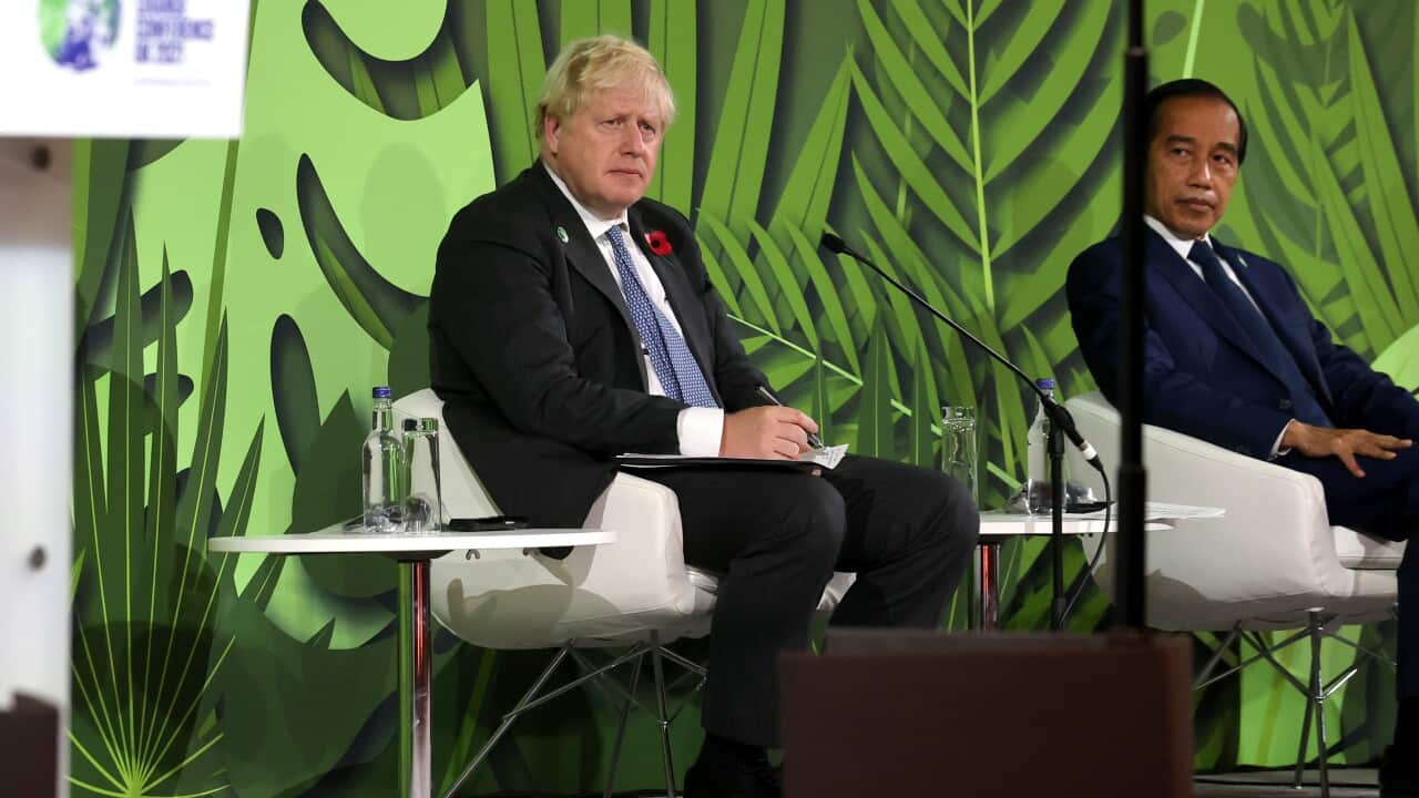 British Prime Minister Boris Johnson and President of Indonesia Joko Widodo seated onstage during an Action on Forests and Land Use event on day three of COP26.