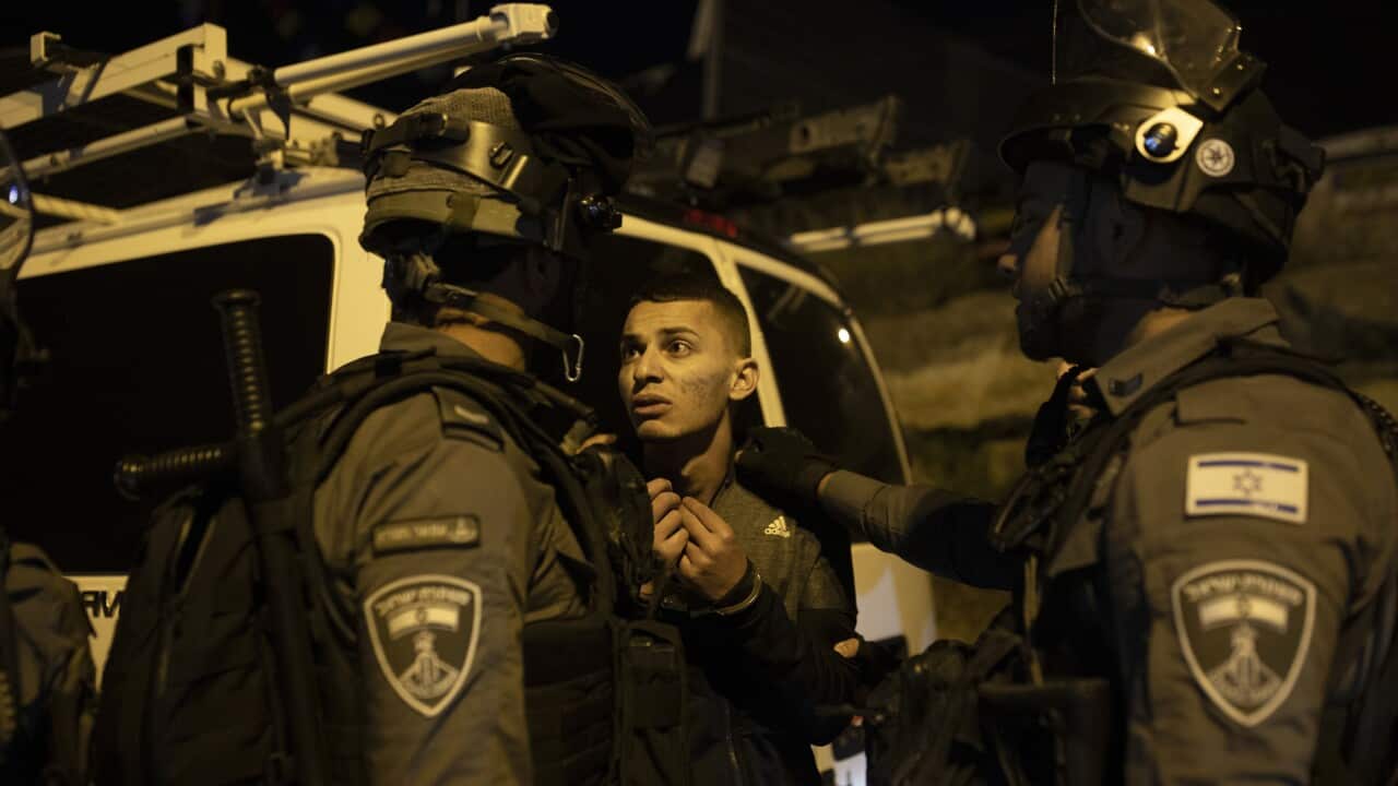 Palestinian youth pleas with Israeli police after he was detained at a protest against forcible eviction of Palestinians from their homes in the Sheikh Jarrah.