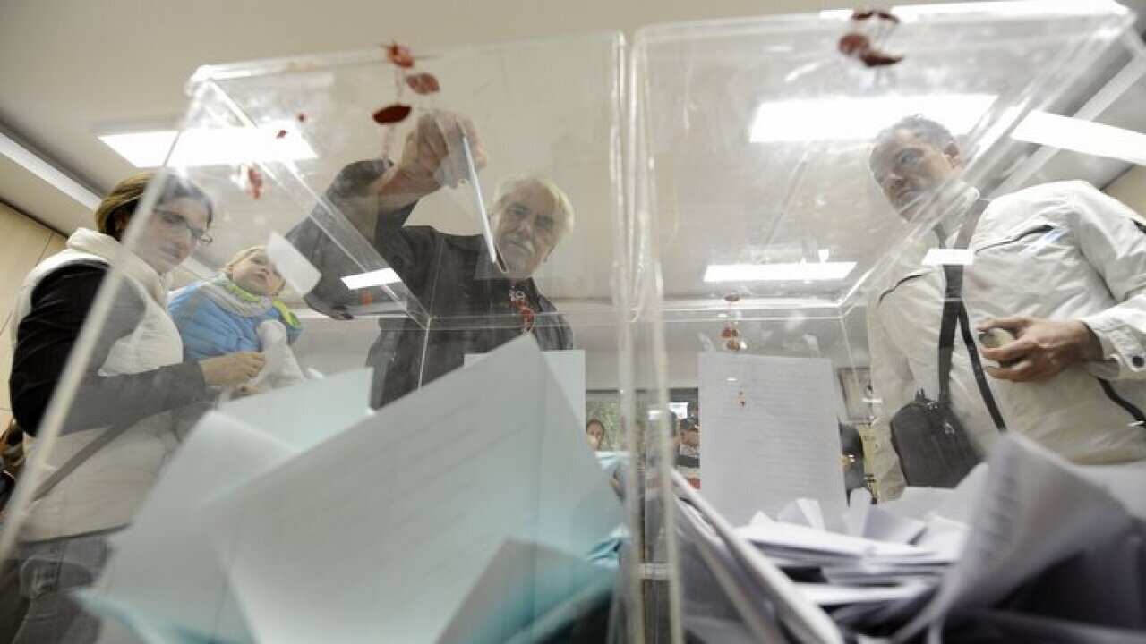 A man casts his ballot at a polling station during elections in Belgrade, Serbia