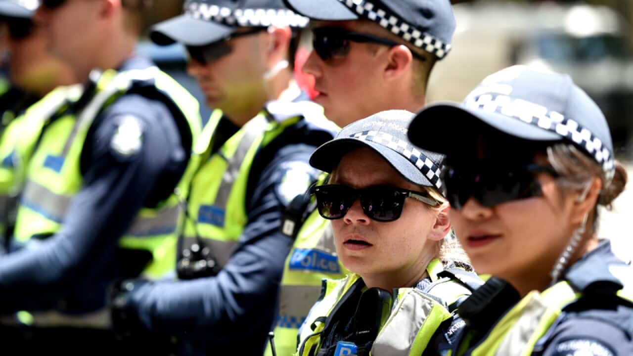 Female police officers with their male collegues