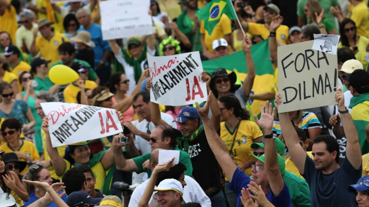 Demonstrators with posters written in Portuguese