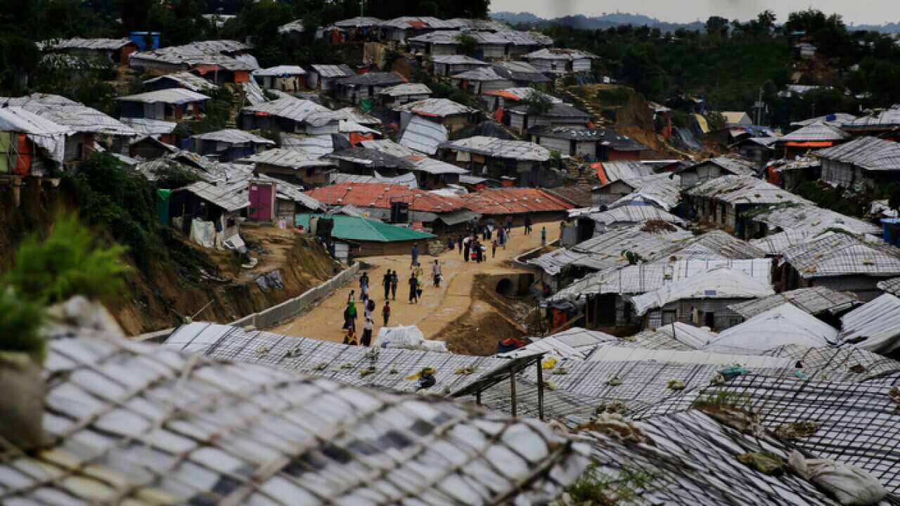 Rohingya refugees walk through a camp in Bangladesh