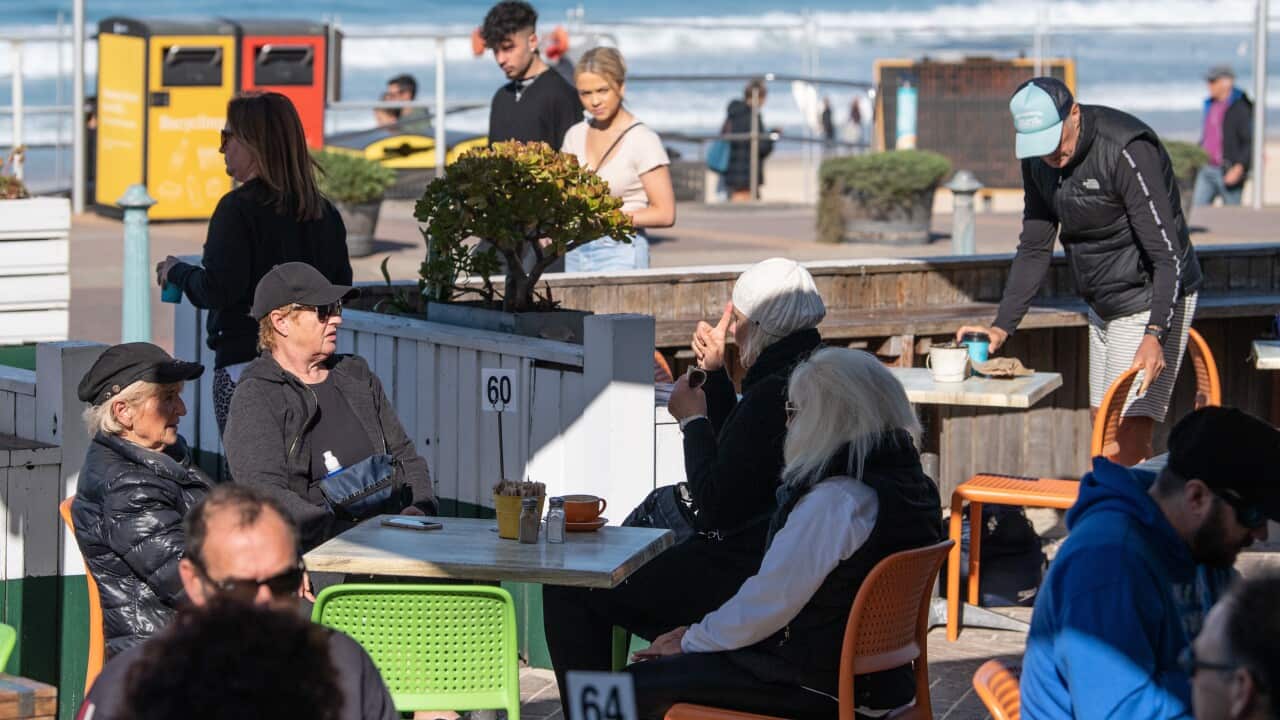 People sitting at a cafe near Bondi Beach in Sydney in June 2020.