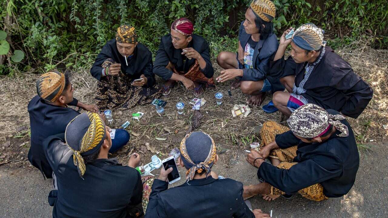 People smoking. Overall there has been an increase in the incidence of smoking in Indonesia since the introduction of COVID-19 social restrictions.