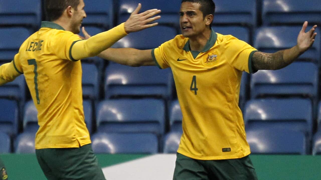 Tim Cahill (R) celebrates scoring against Ecuador