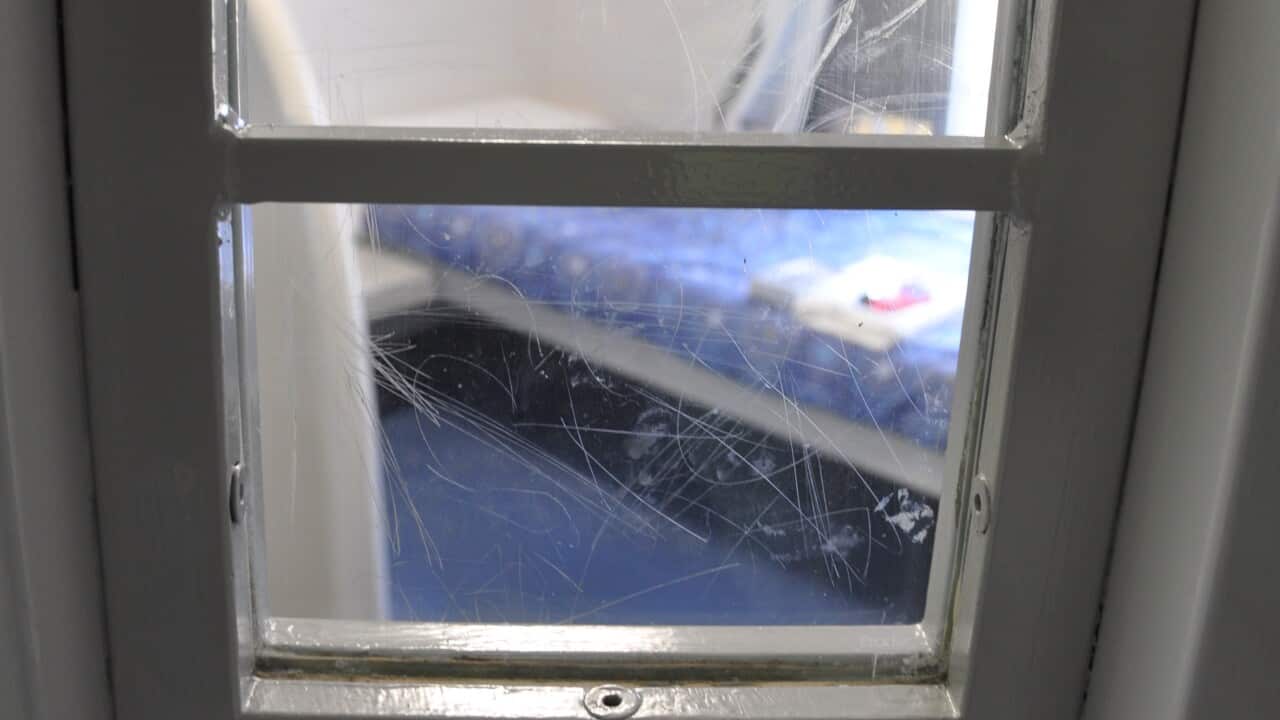 A room with a bed through a door