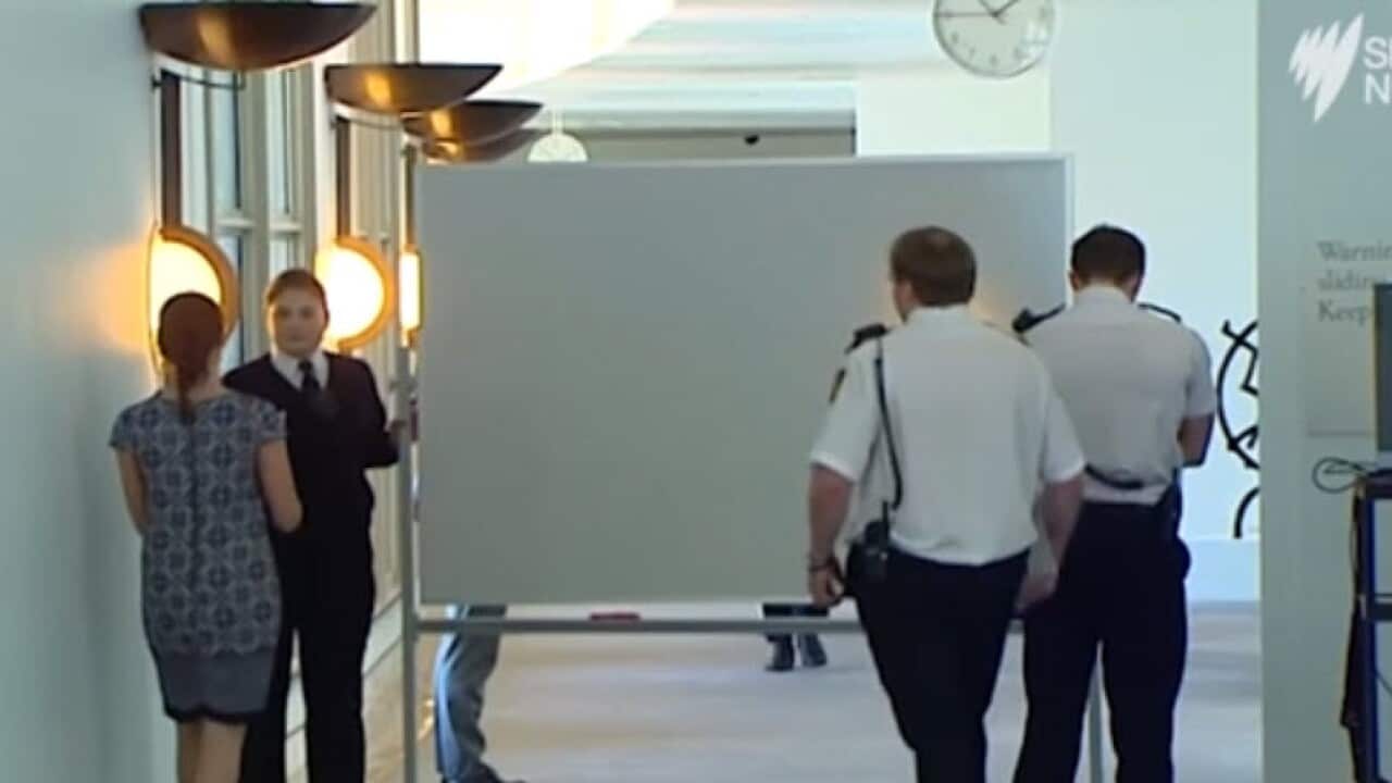 Senator Michaelia Cash uses whiteboard to shield herself from media after rumour threat uproar.