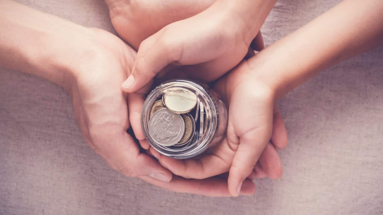 child and adult holding money jar, donation, saving concept
