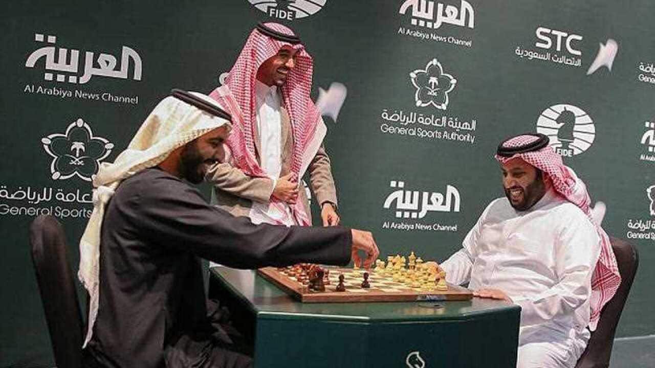 In this Monday, Dec. 25, 2017 photo released by Saudi Press Agency, two Saudi officials play chess during the opening the first ever chess tournament in Riyadh.