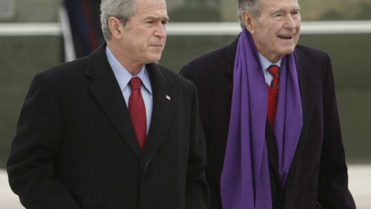Former US presidents George W. Bush (L) and George H.W. Bush