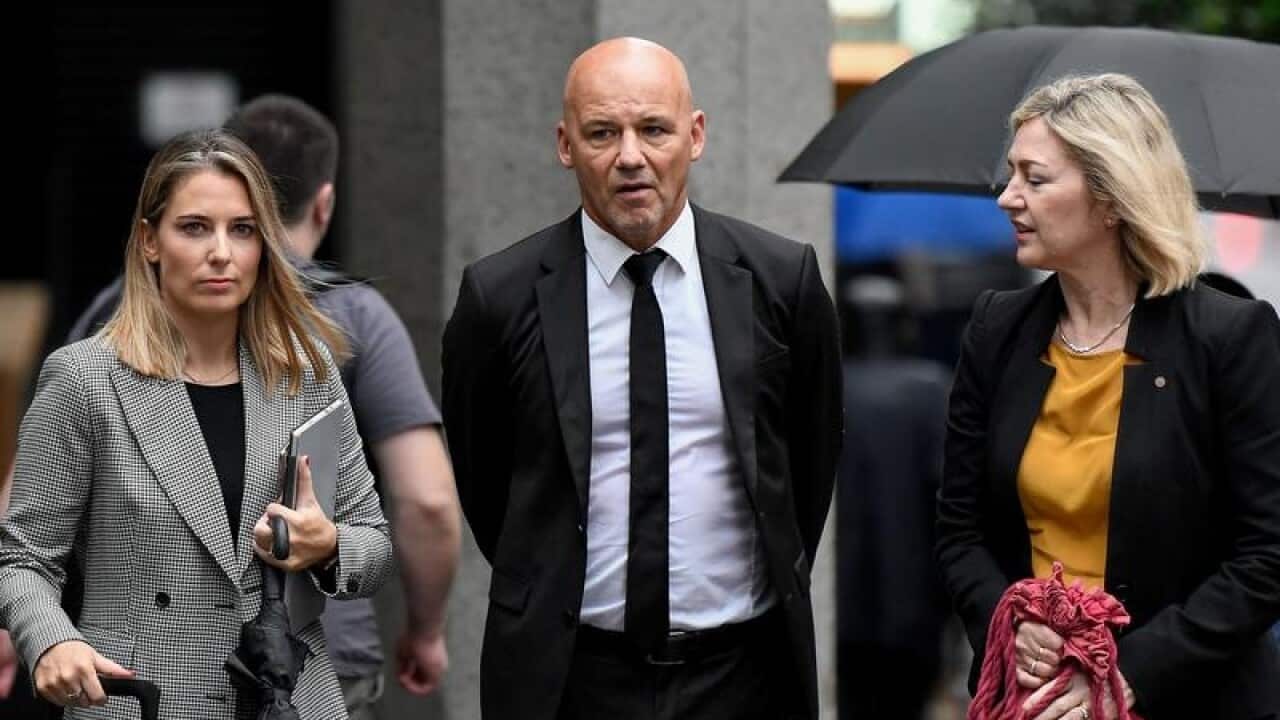 Former detective Gary Jubelin and his lawyers leave court.