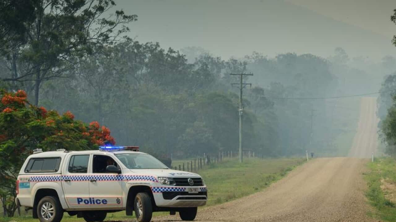 Police are seen checking houses on Muller Road.