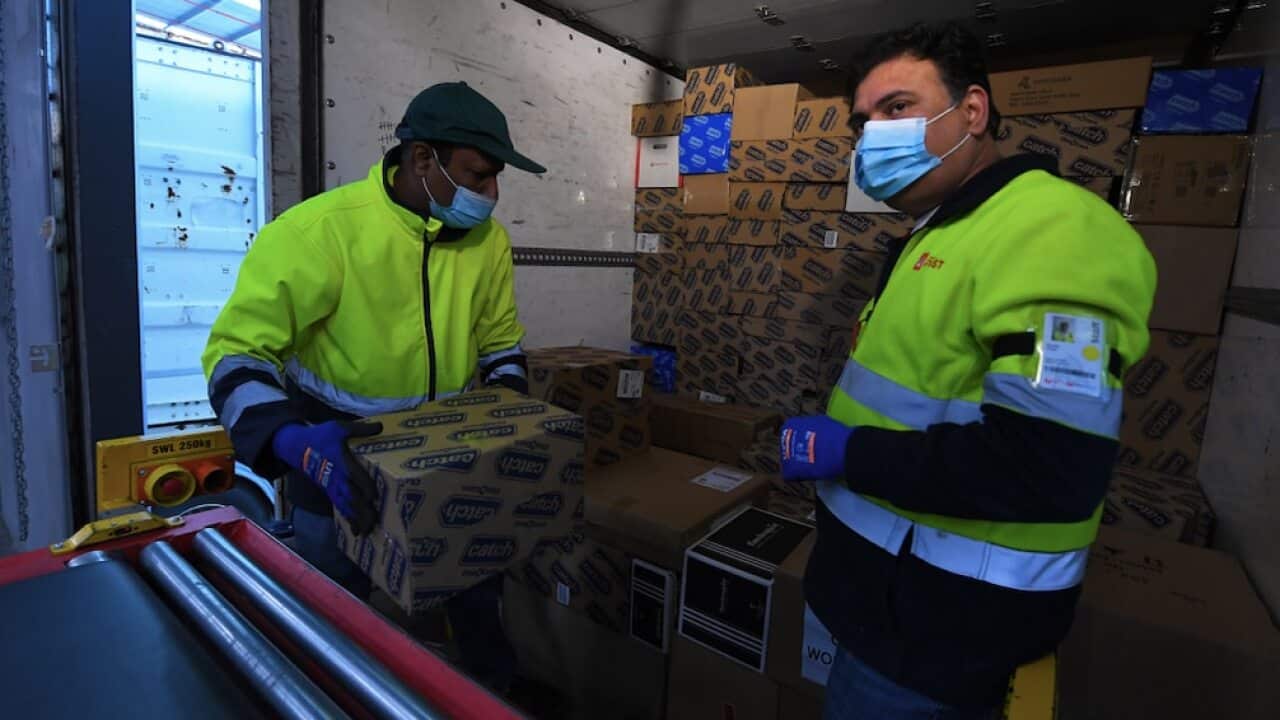 Employees load parcels into a delivery truck at Australia Post’s Sunshine West Parcel Delivery Centre in Melbourne, 16 November 2021.