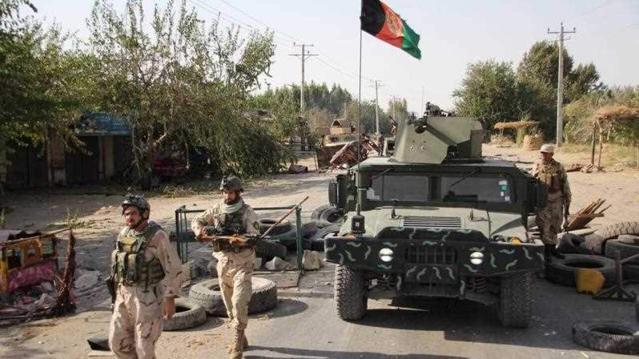 Afghan security officials patrol in Aachin district of Kunduz, Afghanistan
