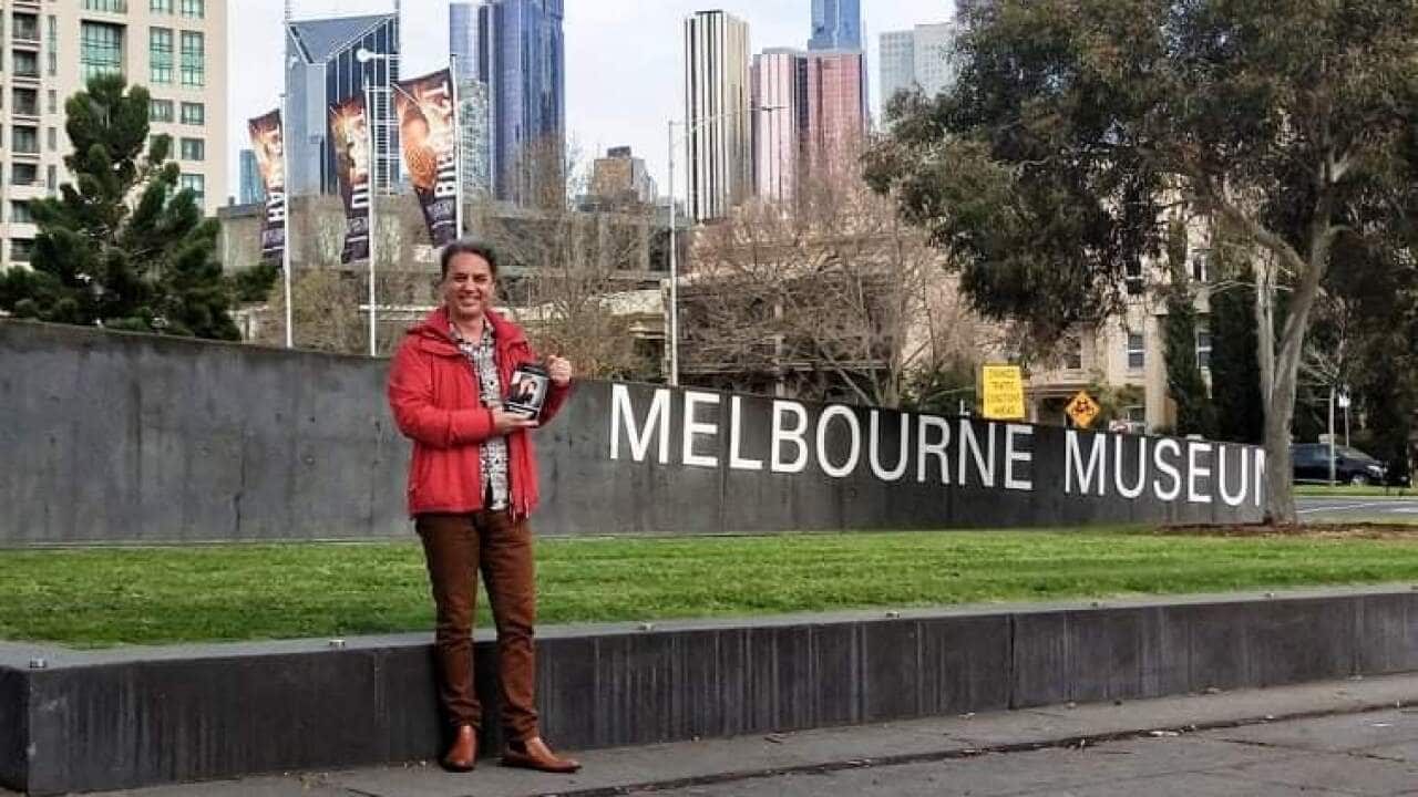 Dr Emil Popordanoski holds his awarded book of poetry