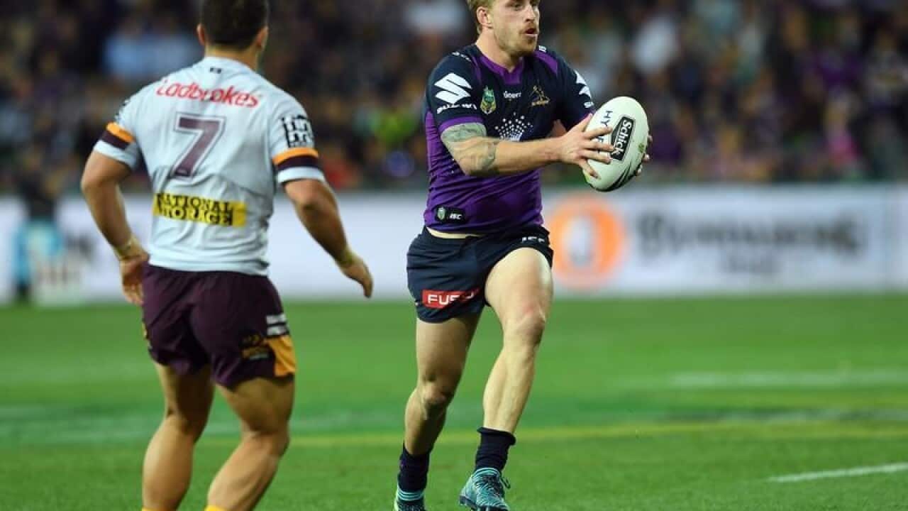 Cameron Munster catches the ball during an NRL game in Melbourne.