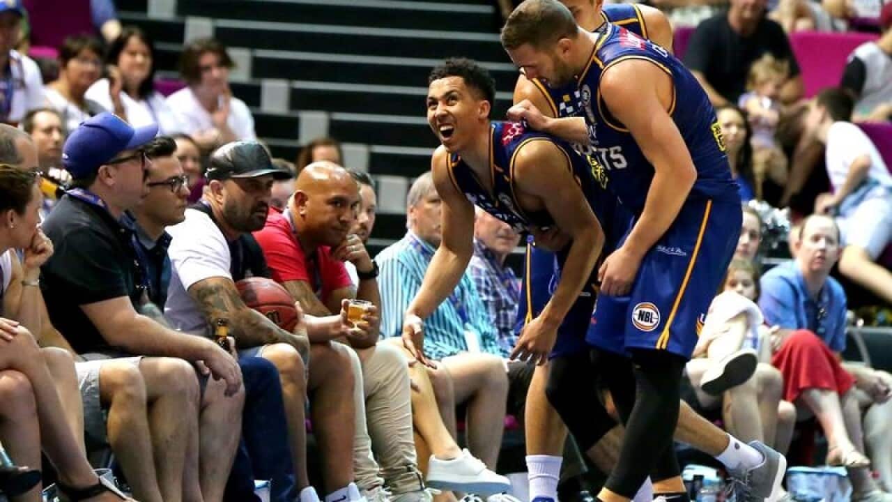 Travis Trice of the Bullets is helped up from the floor.