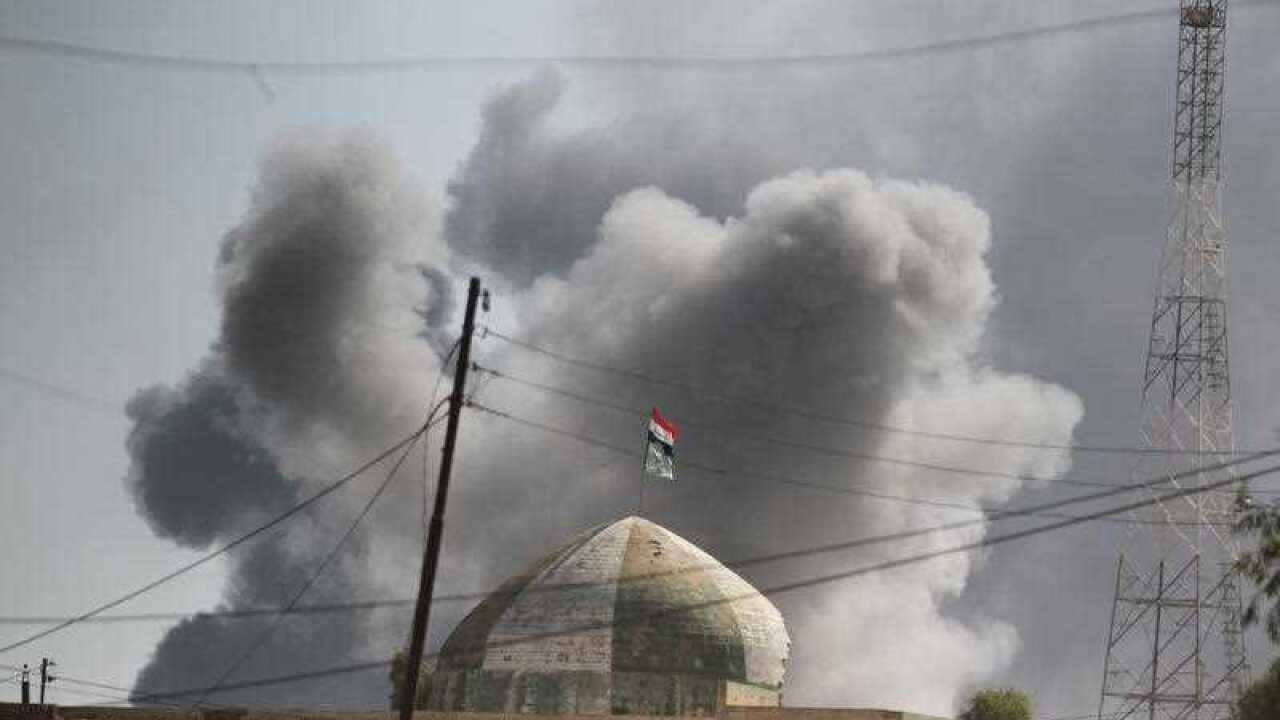 Smoke billows as Iraqi forces, backed by the Hashed Al-Shaabi (Popular Mobilization units), raised the Iraqi flag in the town of Tal Afar, west of Mosul, after the Iraqi government announced the launch of the operation to retake it from IS.