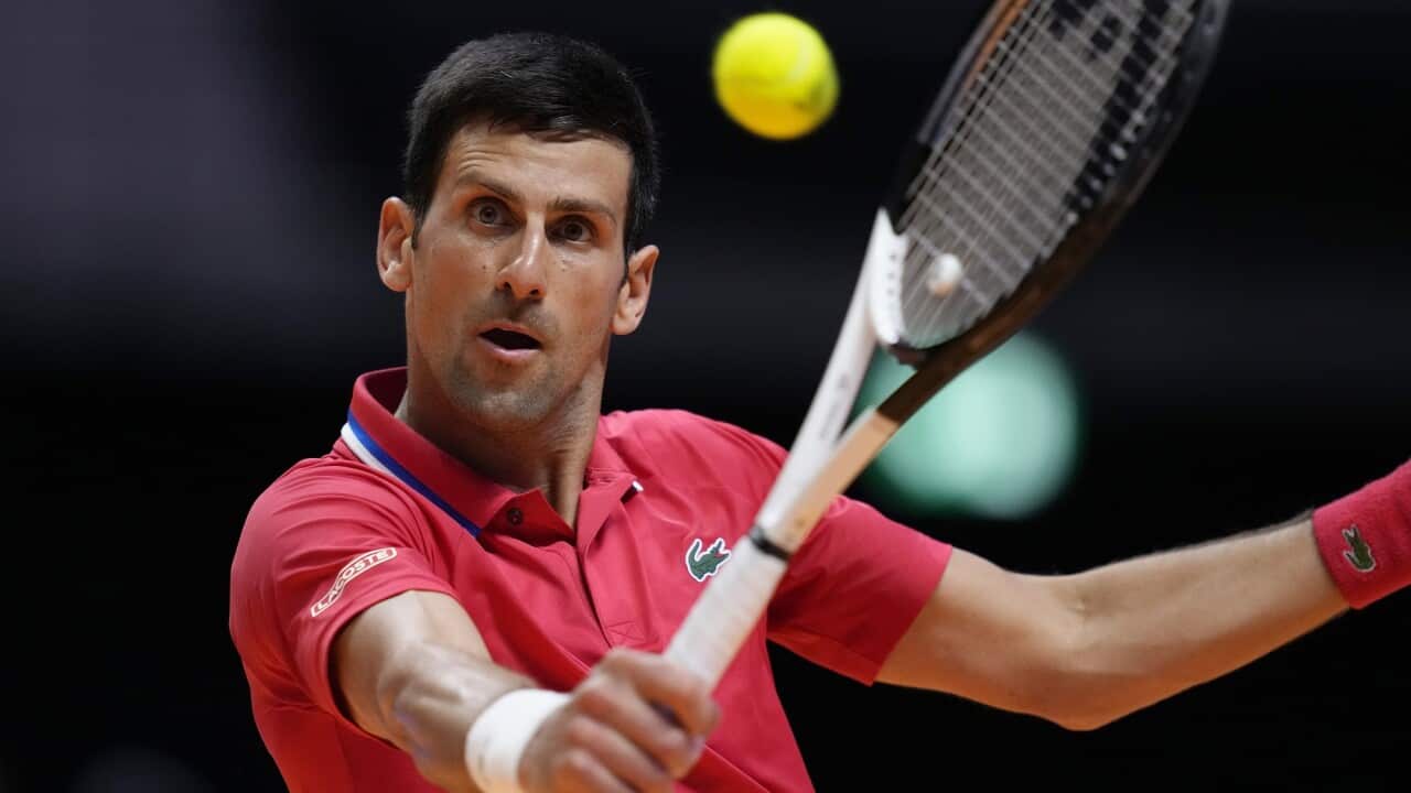 Serbia's Novak Djokovic uses his racket to hit a tennis ball.