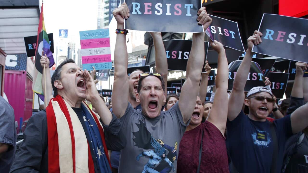 People protest US President Donald Trump announcement that Transgender people will not be allowed to serve in the US military in Times Square in New York