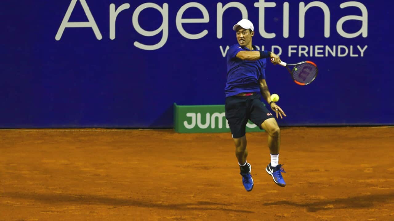 Kei Nishikori of Japan returns the ball to Joao Sousa of Portugal
