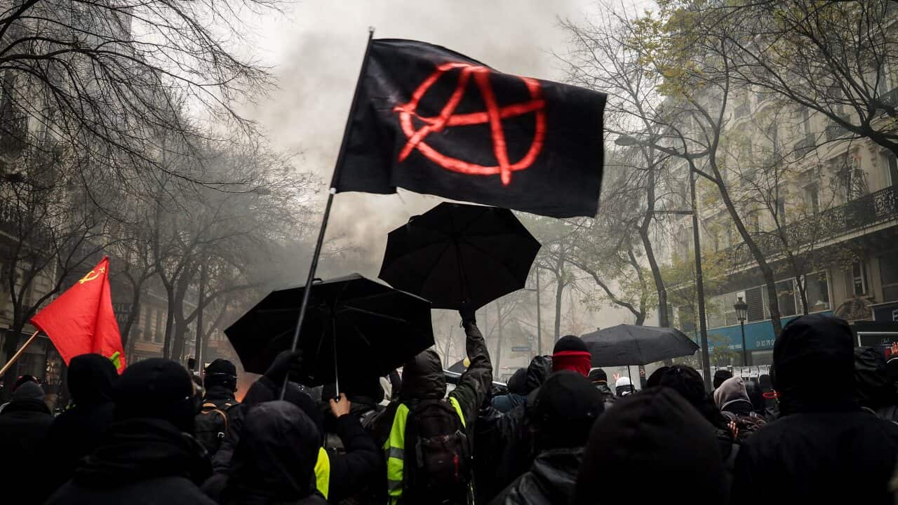 Protesters take part in a demonstration against the pensions overhauls in Paris, France.