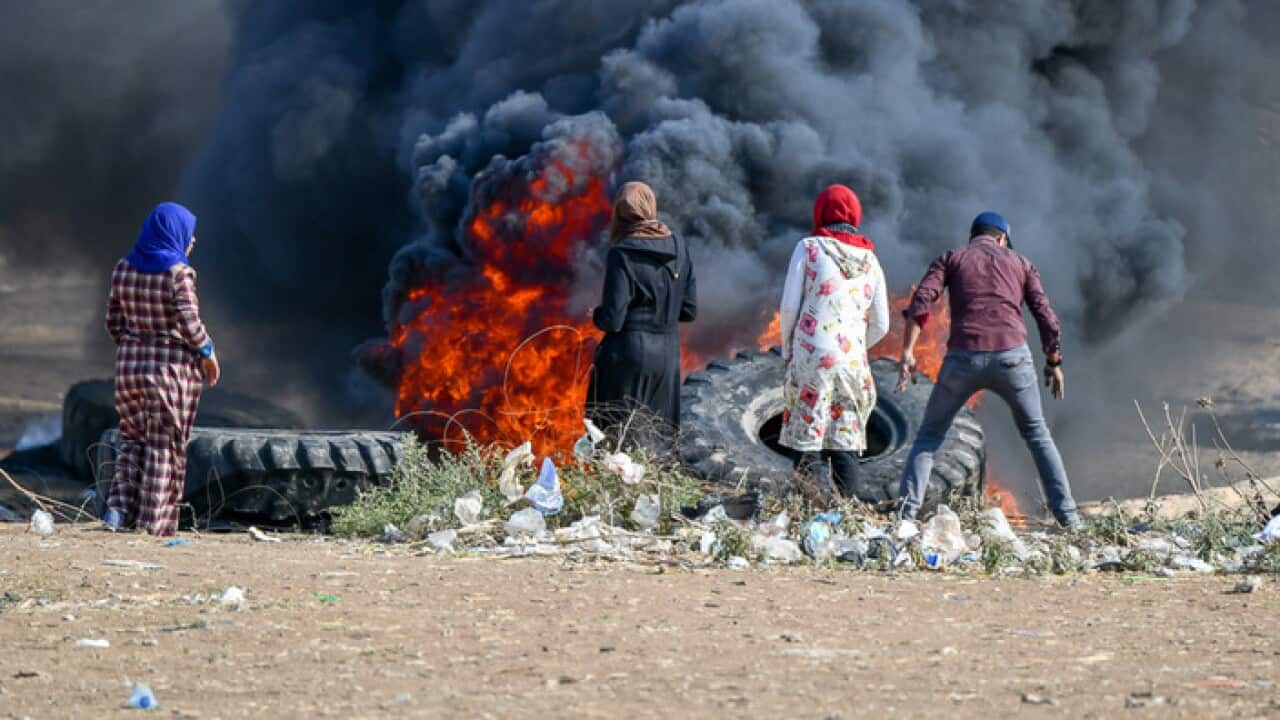 Protesters burn tyres near the Israel-Gaza border