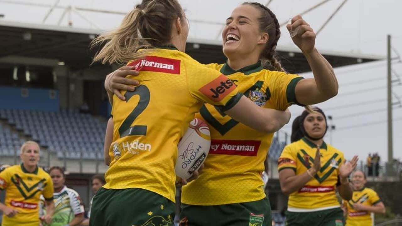 Karina Brown of Australia (right) celebrates after scoring a try