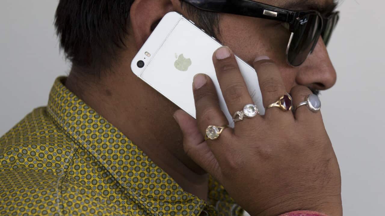An Indian man talks on his iPhone in New Delhi, India