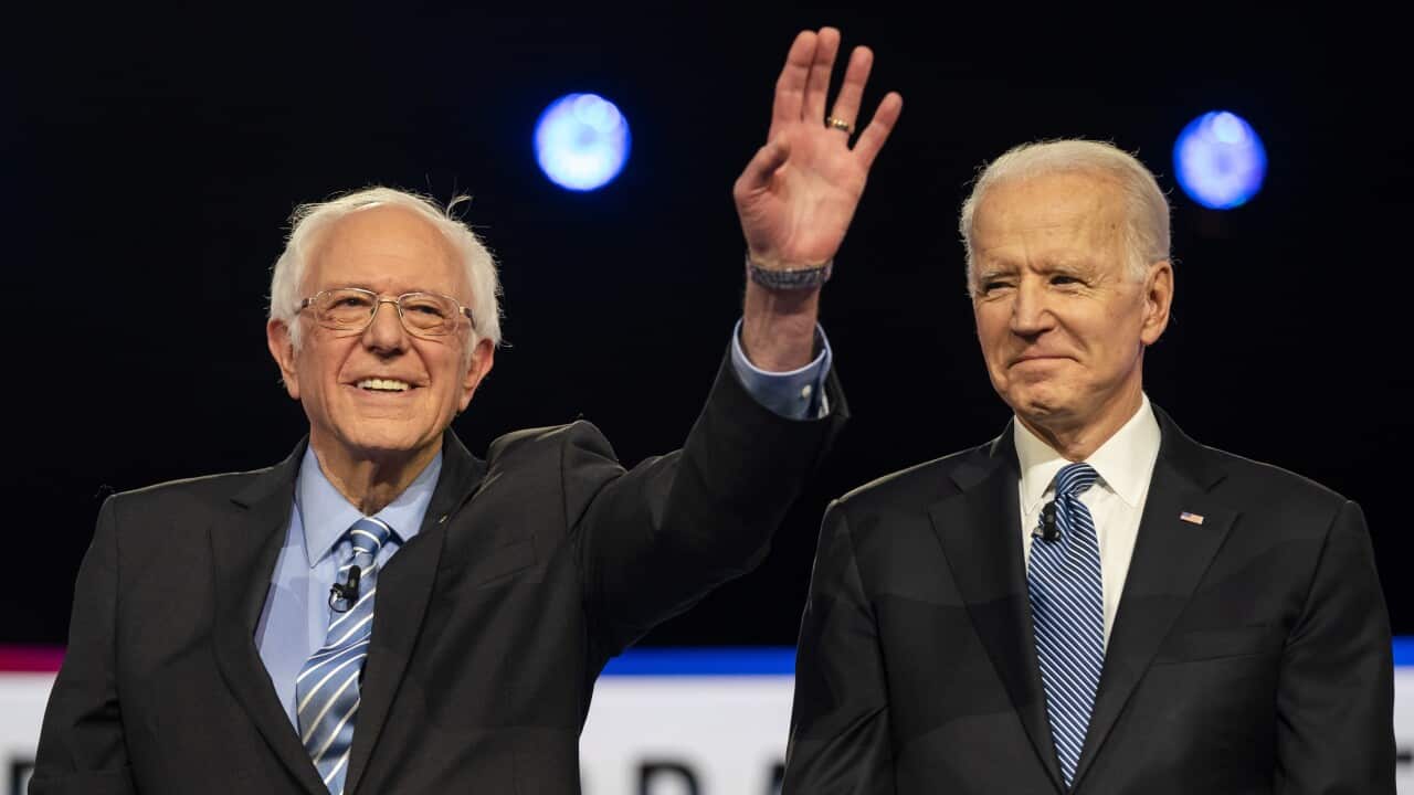 Democratic presidential candidates Bernie Sanders (L) and Joe Biden (R) stand on stage during the tenth Democratic presidential debate.