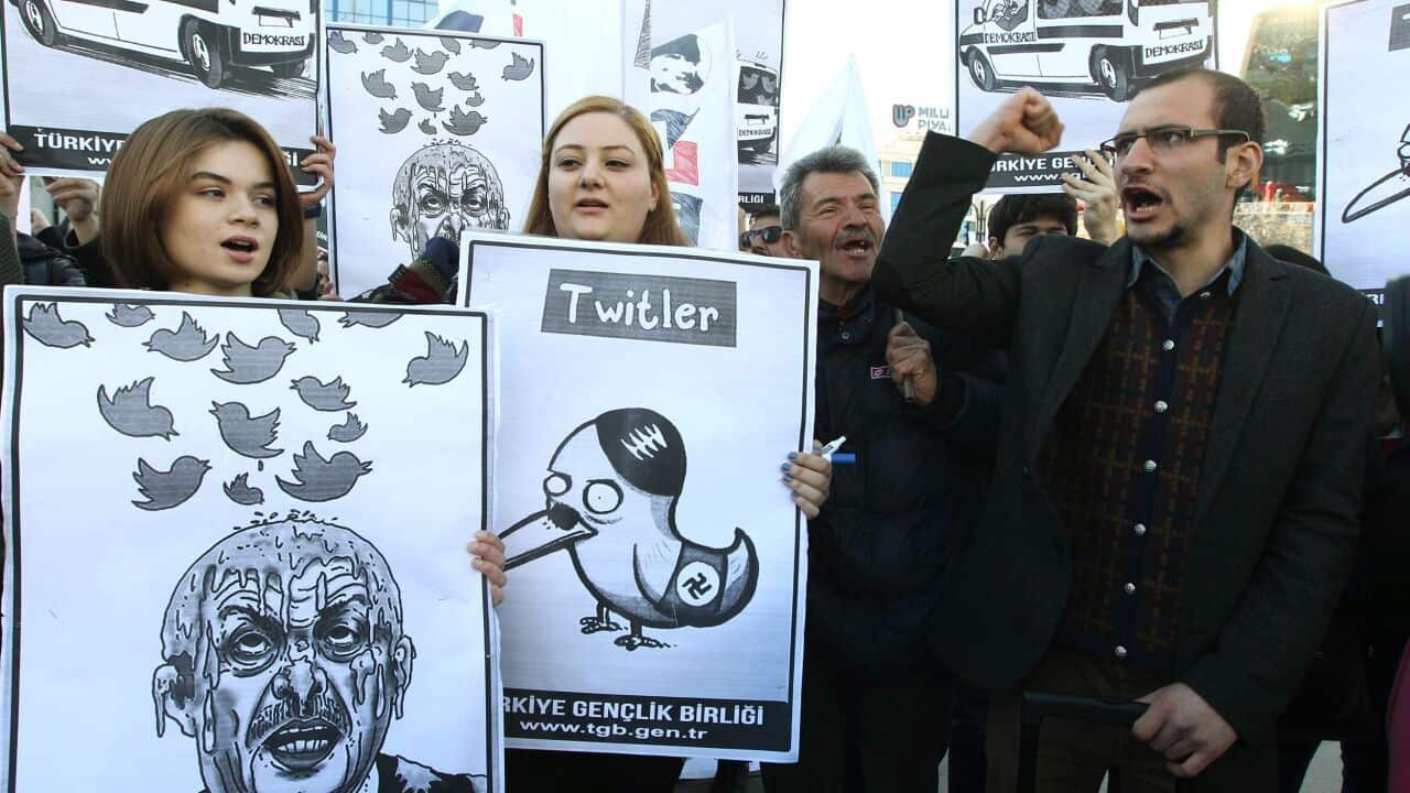 People hold placards as they protest against Turkey's Prime Minister Tayyip Erdogan after the government blocked access to Twitter. (AFP)