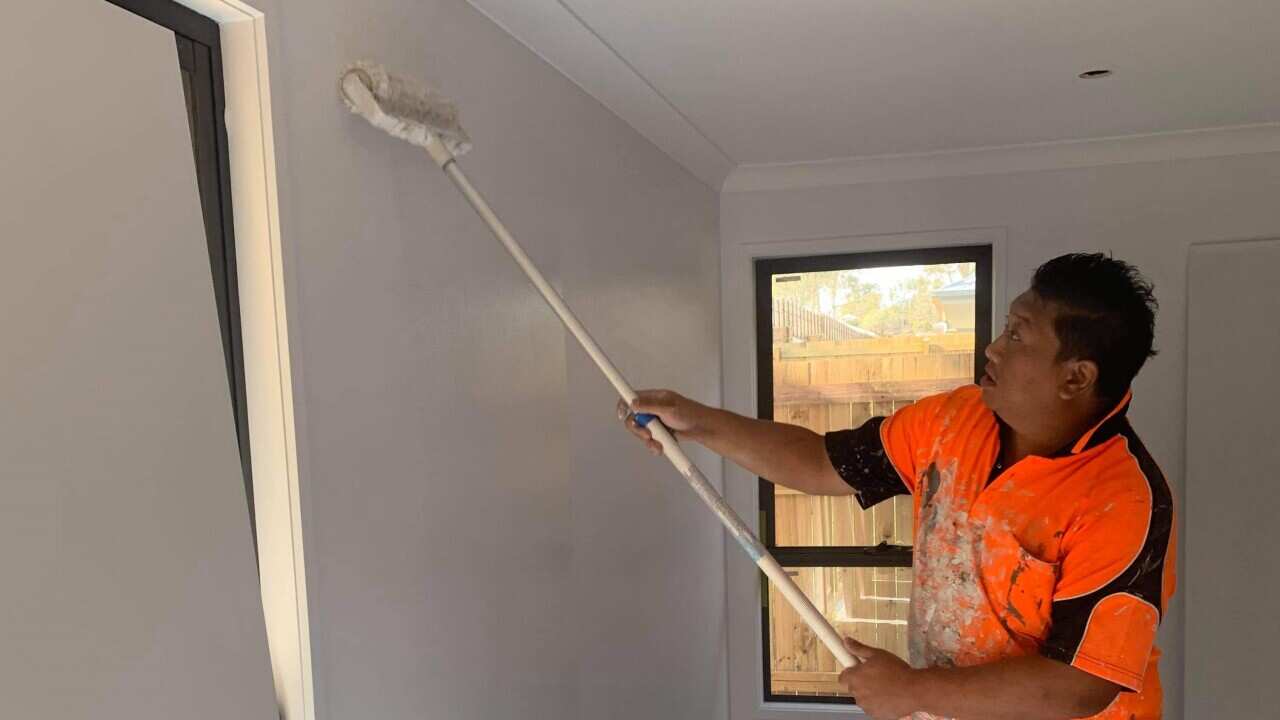 Painting a wall - Chong Cheng Thao