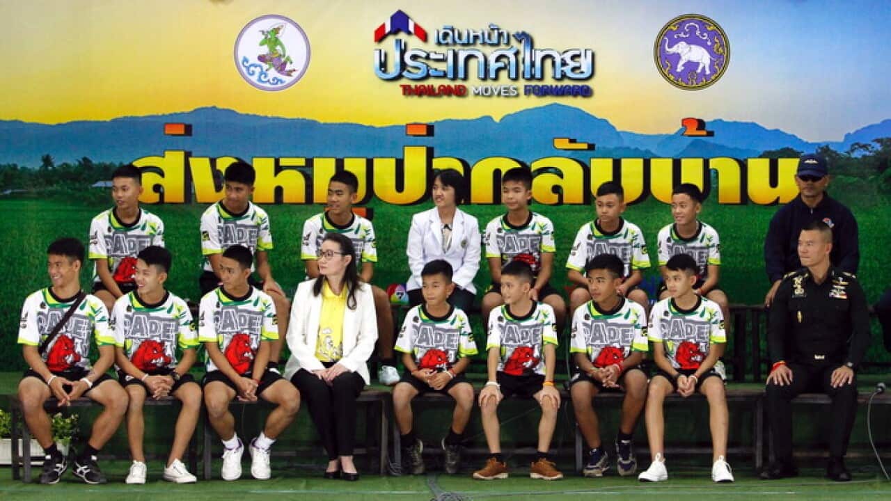The 12 rescued members of the Wild Boar soccer team, with their assistant coach Ekapol Chantawong (front row, L) (AAP)