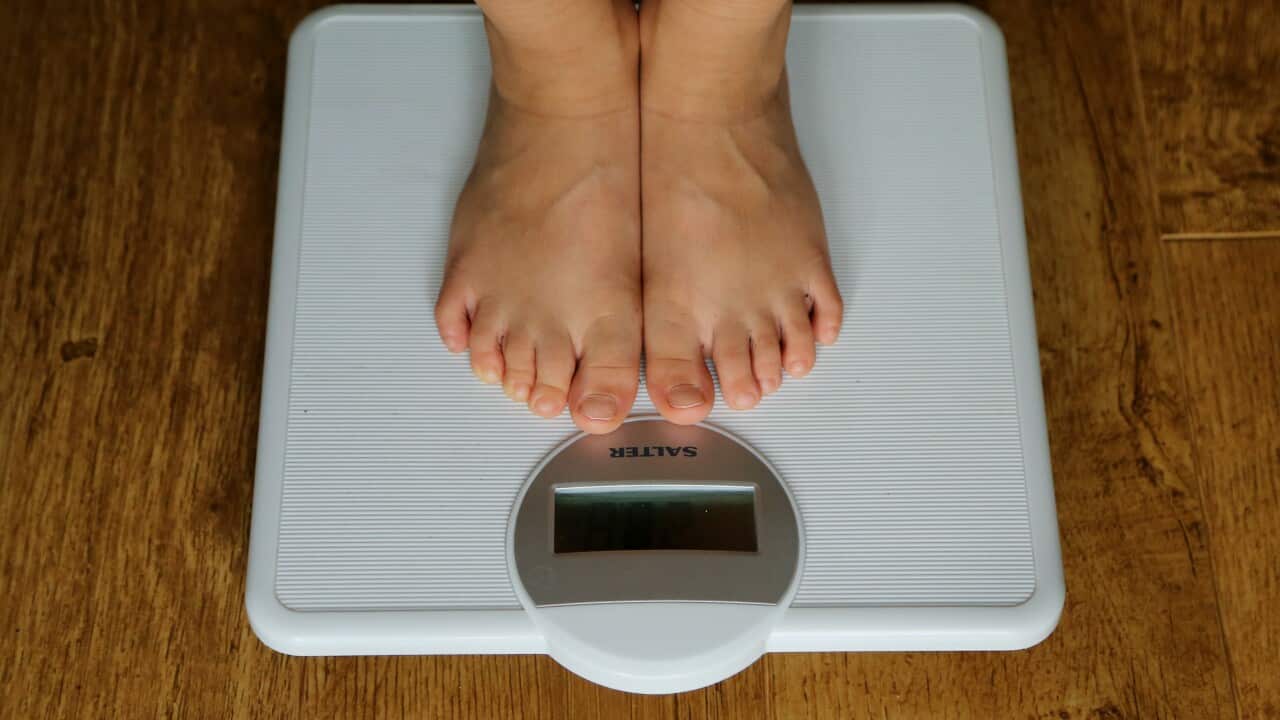 A person standing on a set of scales