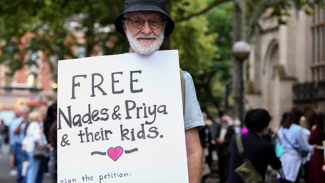 Supporters are seen holding placards during a vigil in support of the Tamil family, in Sydney on 5 March, 2021.