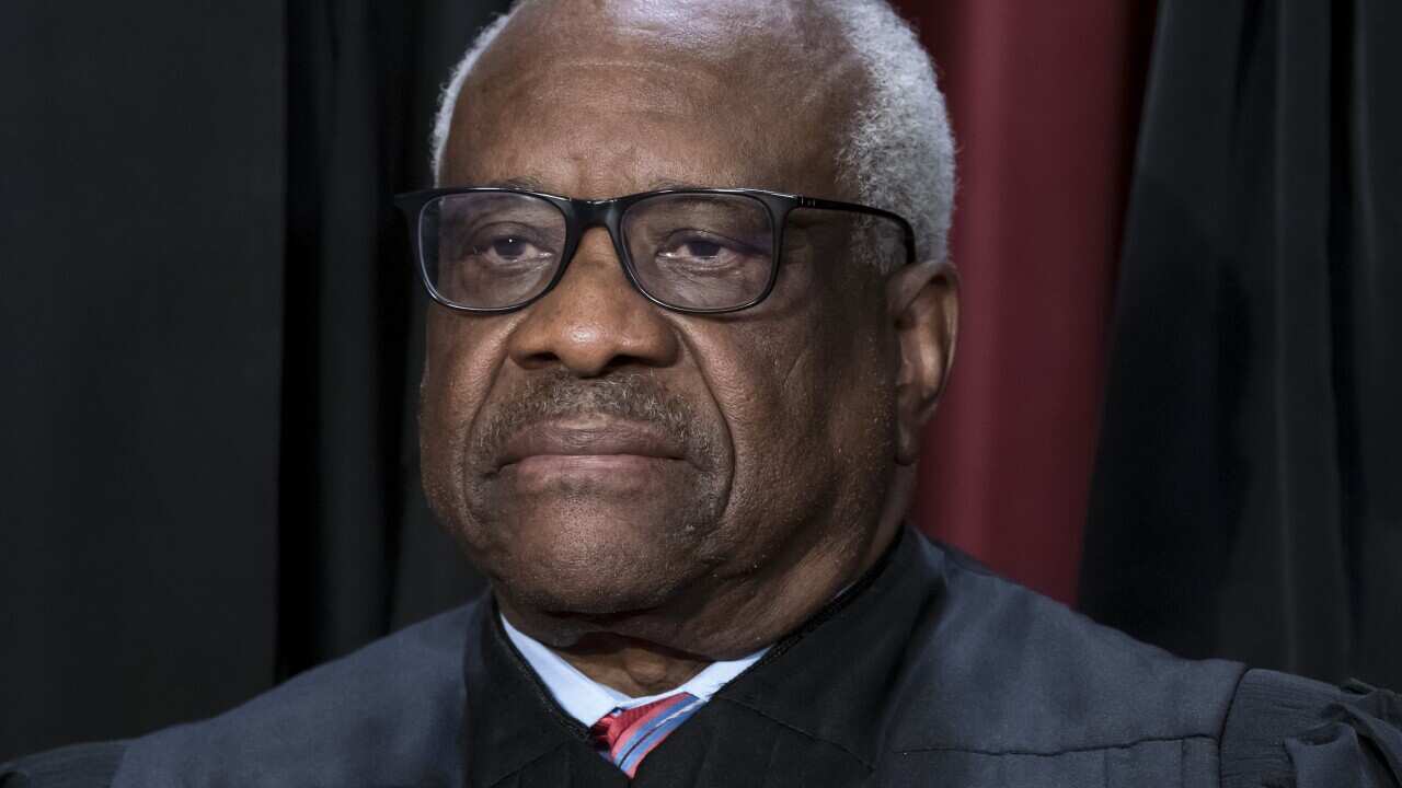 A man wearing glasses looking away from the camera.