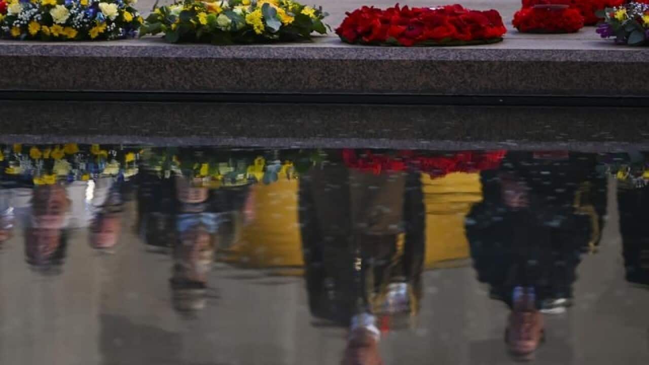 Wreaths lie by the pool of reflection at the Australian War Memorial.