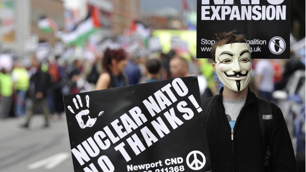 A demonstrator holds a sign