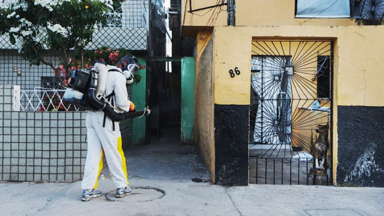 A health worker calls out to residents to remain inside during fumigation in an attempt to eradicate the mosquito which transmits the Zika virus on January 28, 2016 in Recife, Pernambuco state, Brazil.