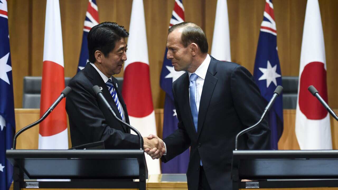 Japanese Prime Minister Shinzo Abe shakes hands with his Australian counterpart Tony Abbott after a joint press conference at the Parliament House in Canberra on July 8, 2014. (AAP)Japanese Prime Minister Shinzo Abe with Tony Abbott at Parliament House in