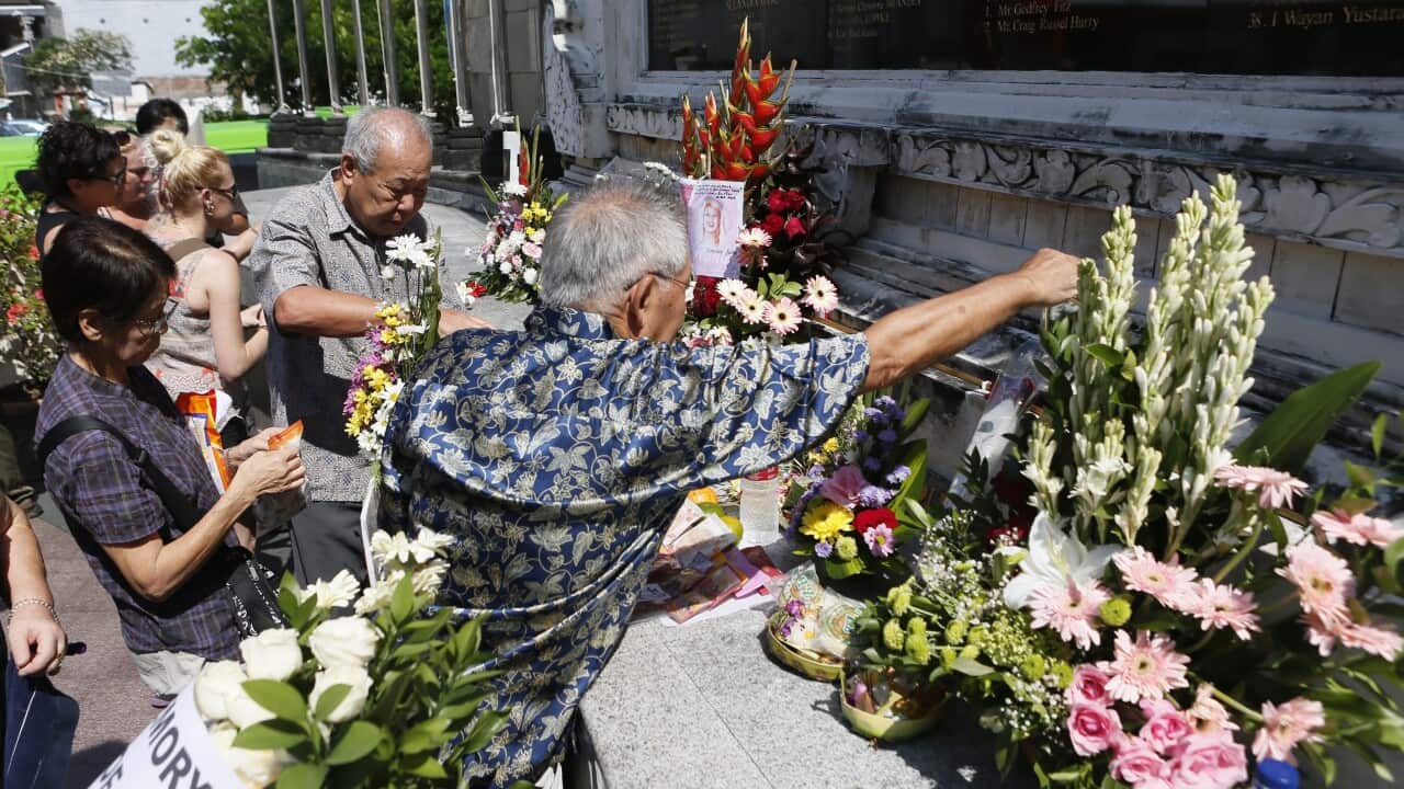 Relatives of the victims of the 2002 Bali bombings mourn in front of the Bali Bombing Memorial during on the 14th anniversary of the bombing